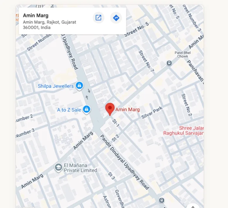 A static map of Amin Marg, Rajkot with a dropped pin on the showroom location and a card showing the address Amin Marg, Rajkot, Gujarat 360001, India